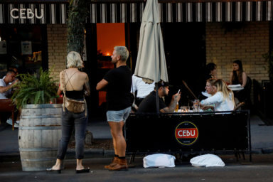 People dine in parking spaces on the street outside CEBU restaurant on the first day of the phase two re-opening of businesses following the outbreak of the coronavirus disease (COVID-19) in Brooklyn, New York