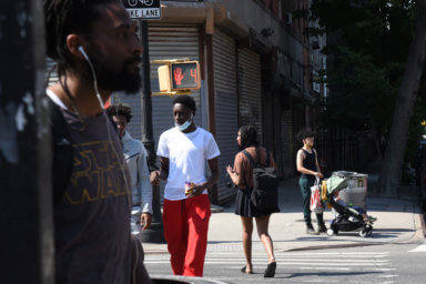 Brooklynites go about their day along Fulton Street on Wednesday, May 19, 2021.