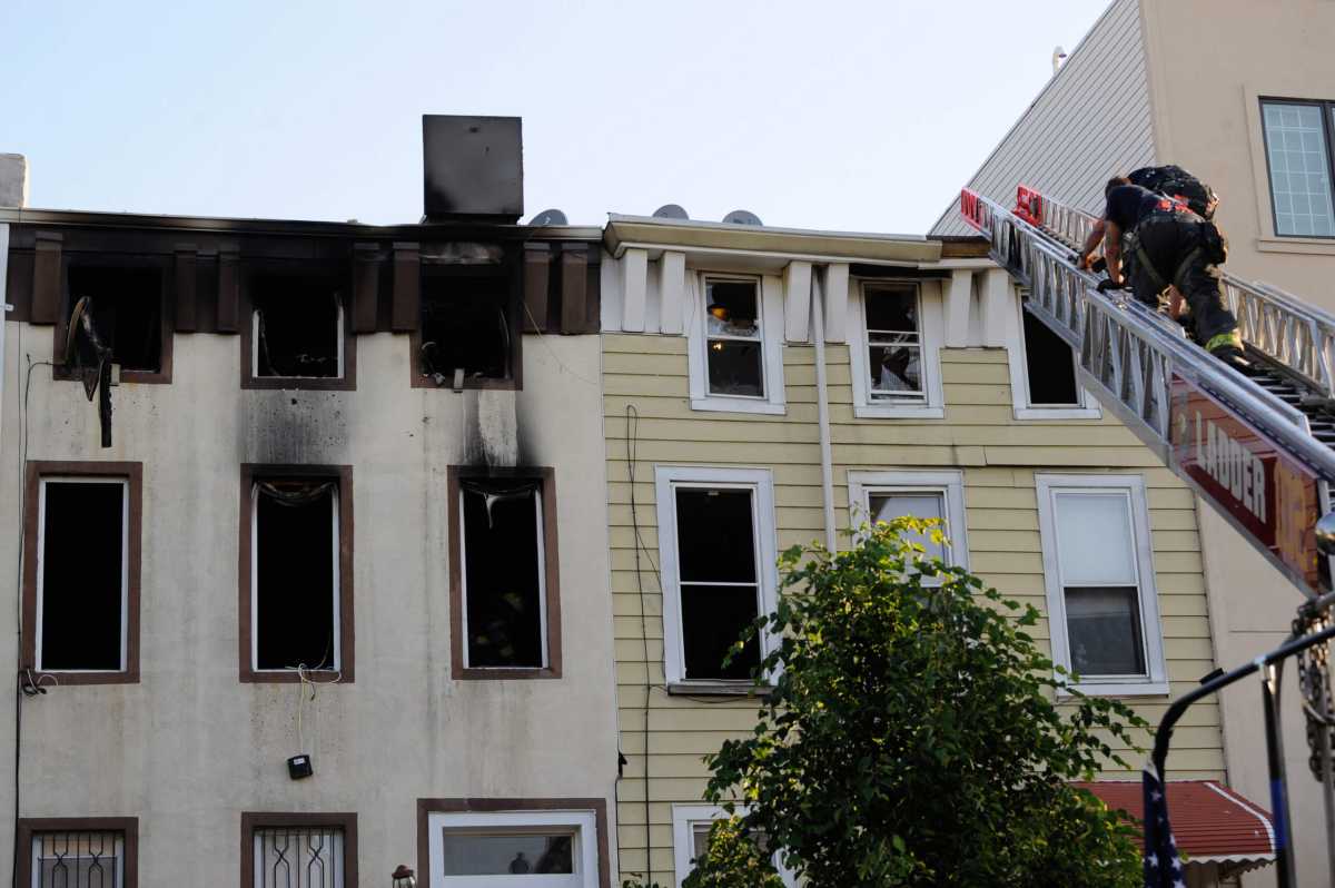 Firefighters work the scene of a two alarm fatal fire at 17 Pulaski Street.