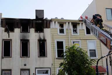 Firefighters work the scene of a two alarm fatal fire at 17 Pulaski Street.