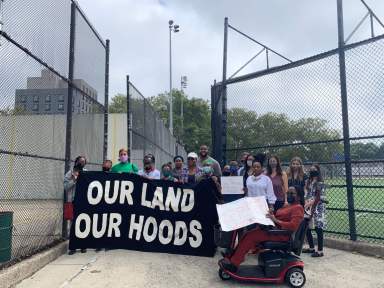 People stand with signs against National Grid and the North Brooklyn Pipeline