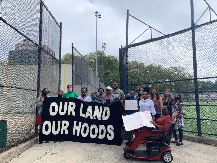 People stand with signs against National Grid and the North Brooklyn Pipeline