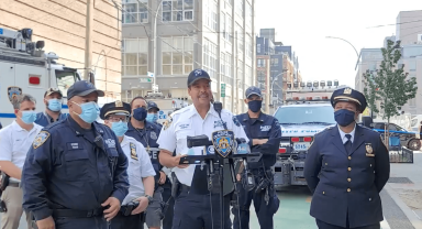 NYPD officers discuss the arrest of a graffiti artist who hid in a greenpoint water tower