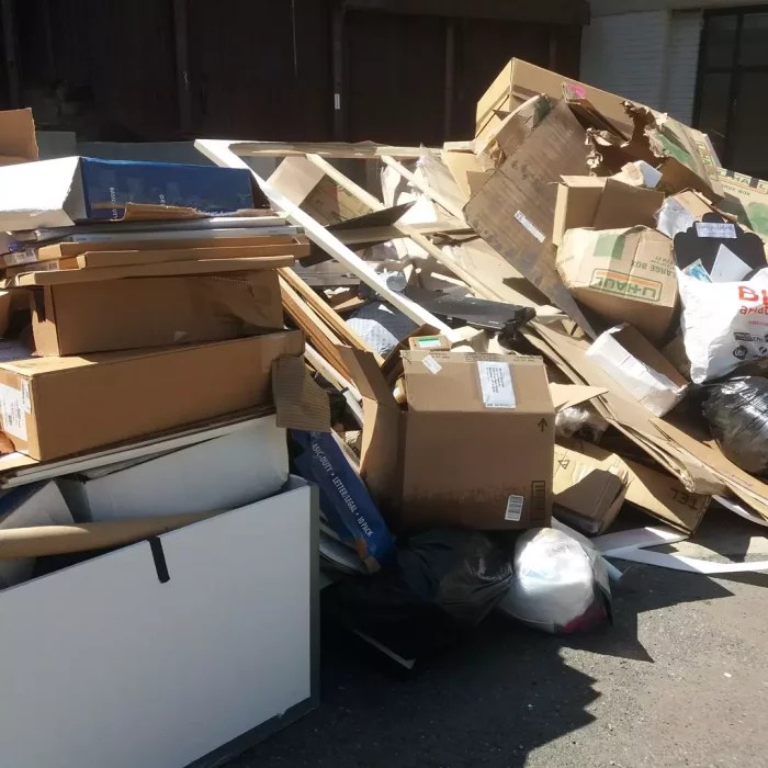 A pile of furniture and boxes being thrown away after flooding