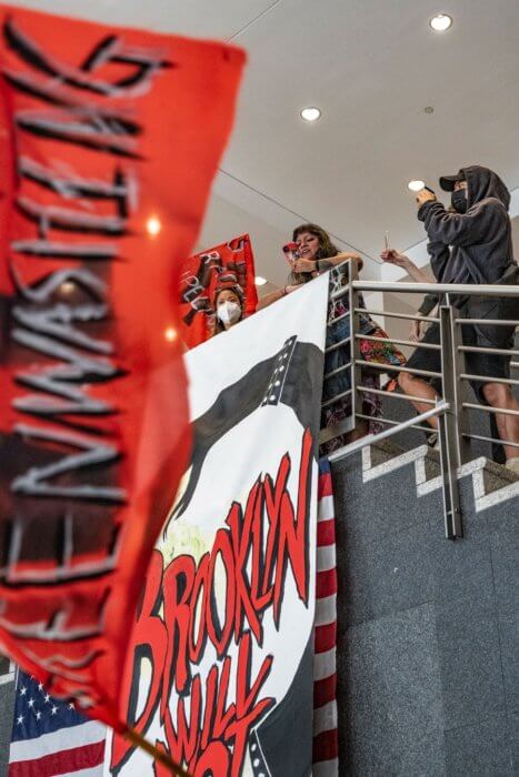 Protesters in National Grid's lobby are against the gas company's sponsorship of Climate Week NYC