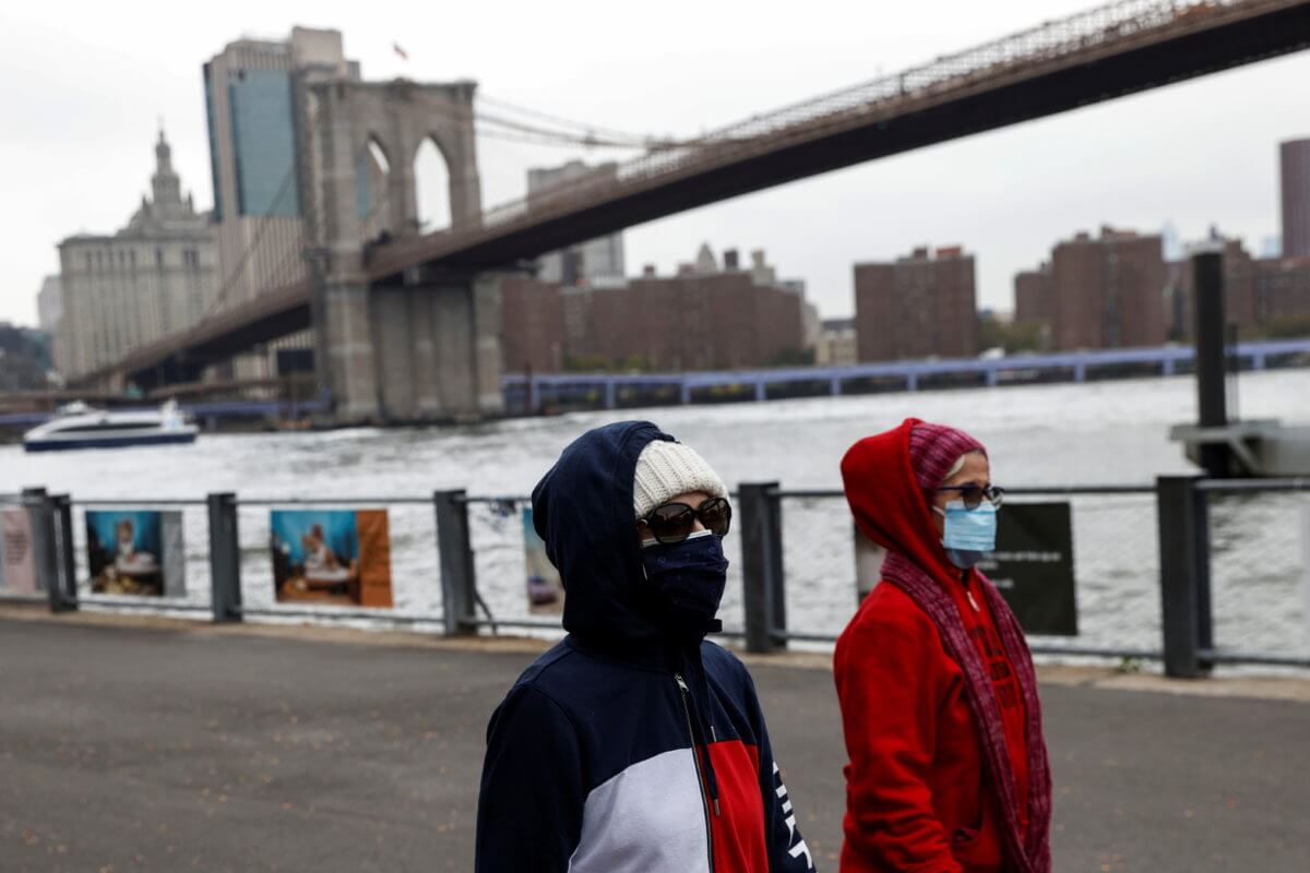 Women walk with protective face masks amid the coronavirus disease (COVID-19) pandemic in Brooklyn