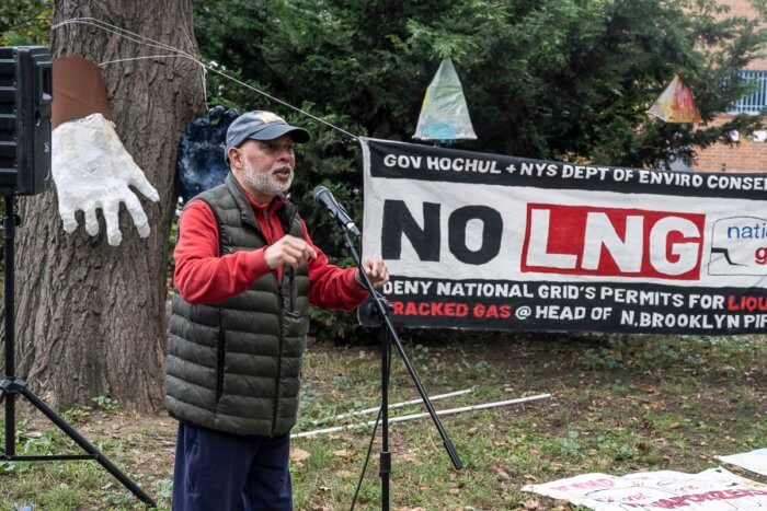 man speaking at rally against greenpoint energy center