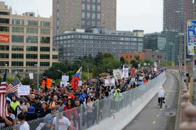 Protestors walk the Brooklyn Bridge.