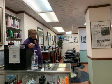 Thomas LaMarca poses in his Clark Street station barber shop
