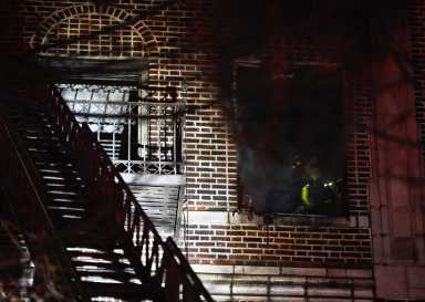 A firefighter operates in the fire apartment.