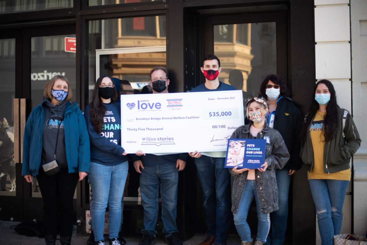 debbie and brooklyn bridge animal welfare coalition volunteers with the grant check from petco love
