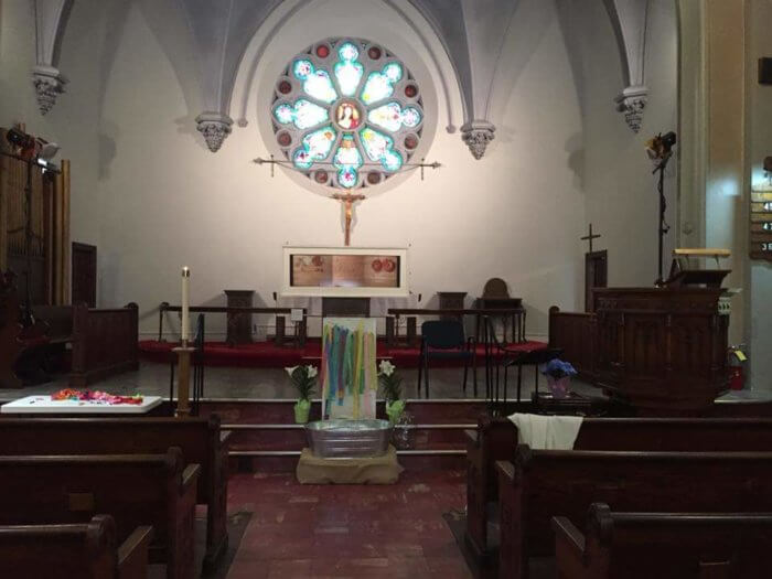 interior of park church co-op with pews and rose windows