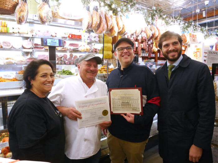 milano market owners pose at the opening of the new store