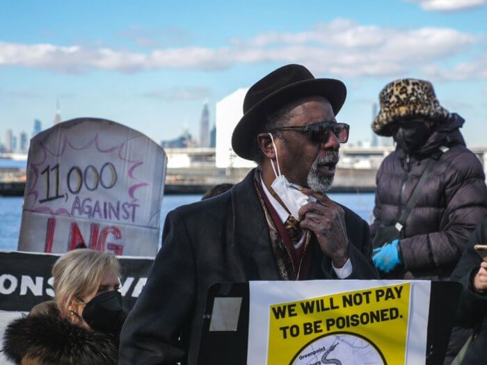 elisha frye stands in front of the greenpoint energy centers