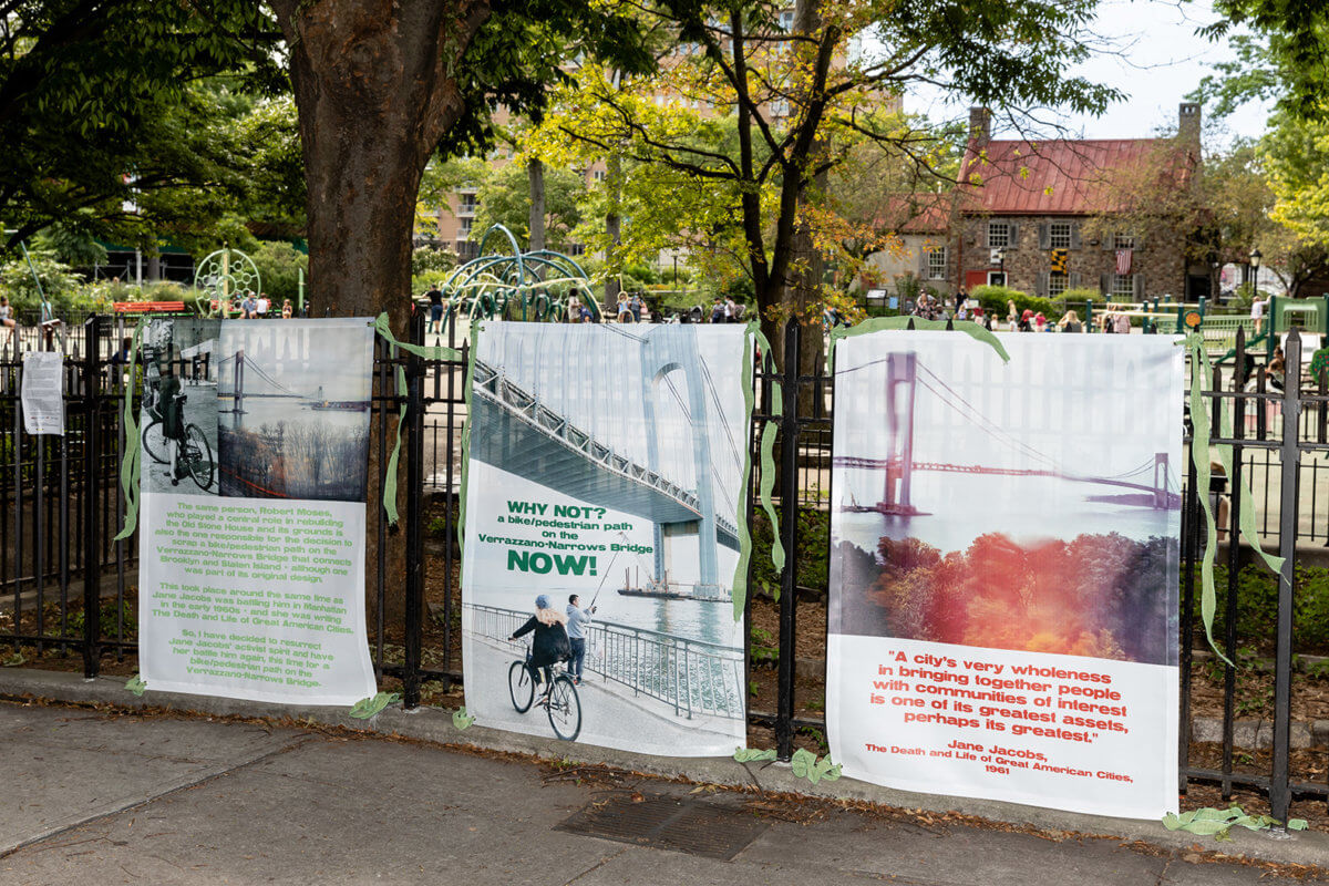 banners hung on a fence for brooklyn utopias.