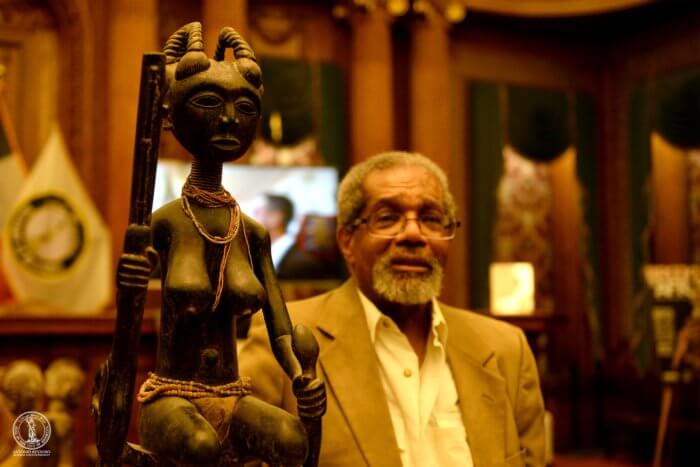eric edwards looks at a statue at brooklyn is africa