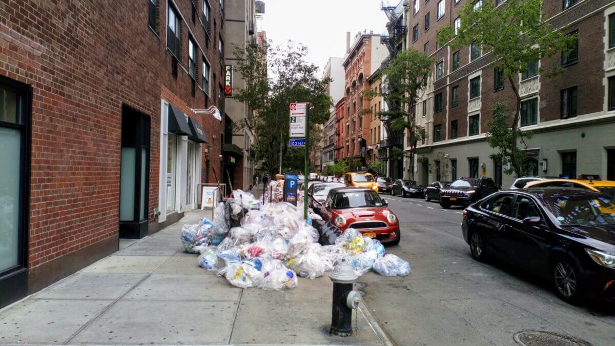 trash in bags on sidewalk community cleanup plan