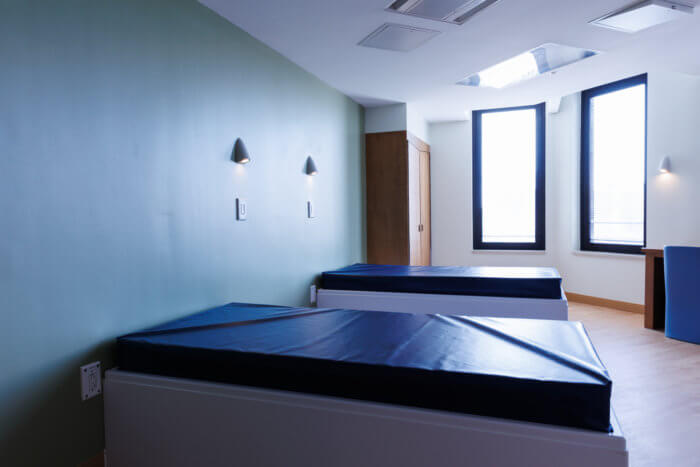 room at interfaith medical center with two beds and two windows
