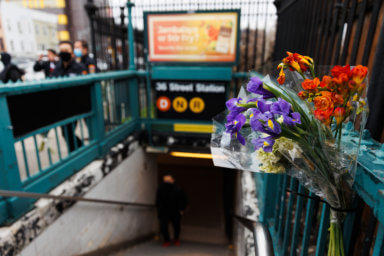 flowers on fence outside 36th street subway station in sunset park