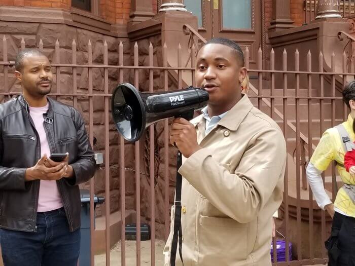 chi ossé with bullhorn at rally. ossé voted against city budget