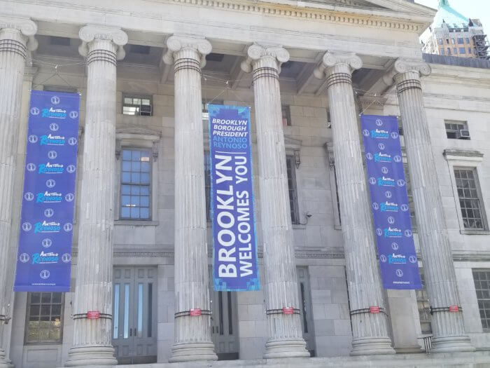 antonio reynoso flags hang on brooklyn borough hall