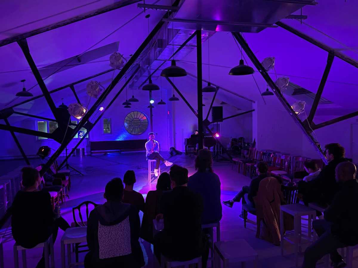 people watch a performance at super secret arts