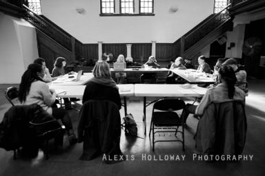 people sit around a table at a voices of lefferts workshop
