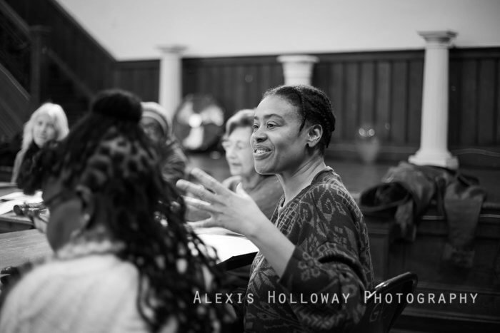 woman talking at a table at a voices of lefferts workshop