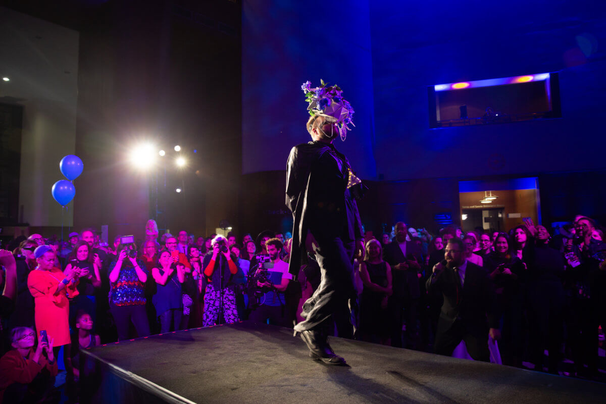 person on stage at brooklyn public library at the people's ball