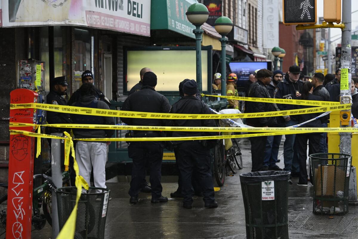 cops stand with caution tape at sunset park station after shooting