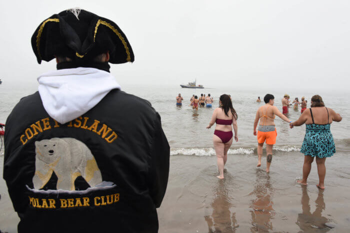 person watching polar bear plunge