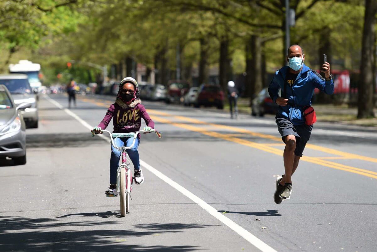 father and daughter on open street