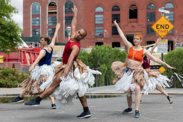 people in white skirts dance at brooklyn utopias along the canal