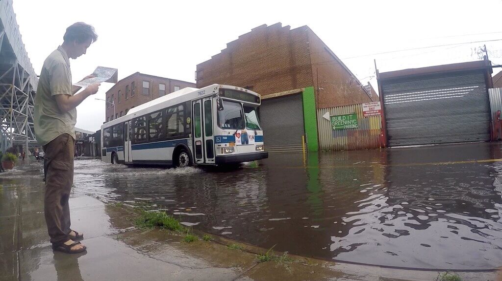 person in floodwater bioswales in brooklyn