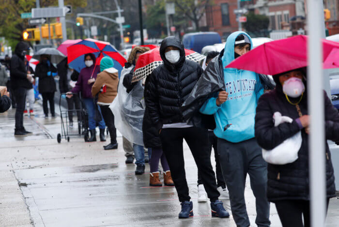 People in line in the rain for a food pantry. One in three brooklynites struggle with food insecurity