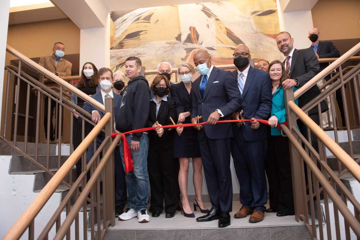 adams cutting ribbon at nevins street apartments