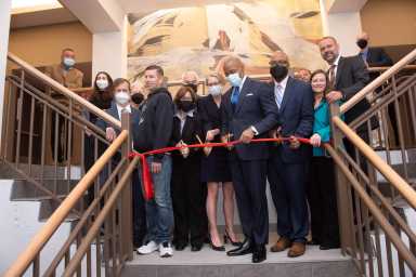 adams cutting ribbon at nevins street apartments