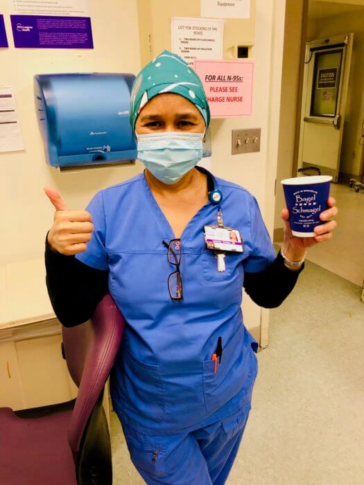 adel teodoro gives a thumbs up in blue scrubs during national nurses week