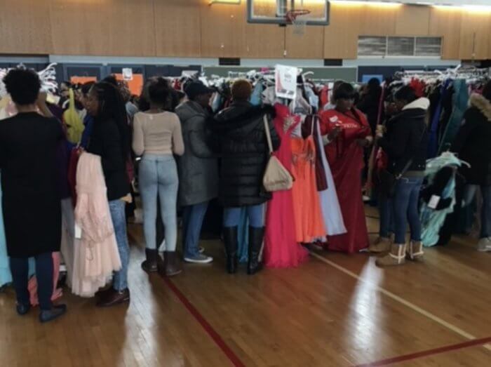 students look at dresses at operation prom
