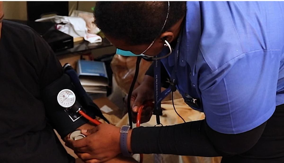 home care nurse sherill stennett takes a patient's blood pressure