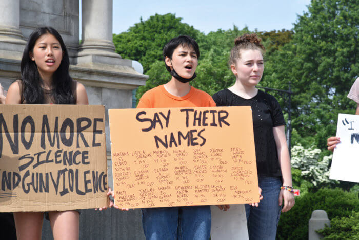 students chant while holding signs at gun reform protest