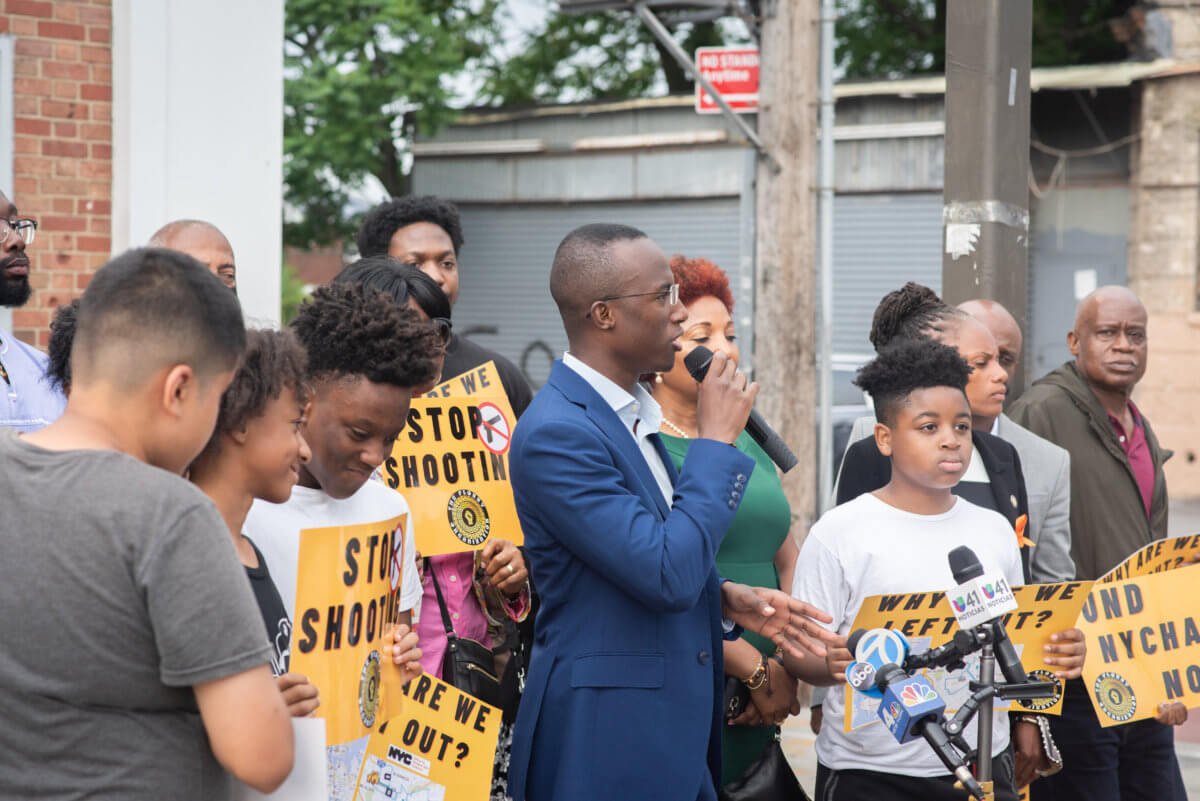 jibreel jalloh in suit at canarsie anti-violence rally