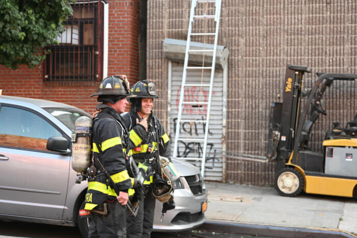 firefighters at two-alarm fire at greenpoint furniture shop