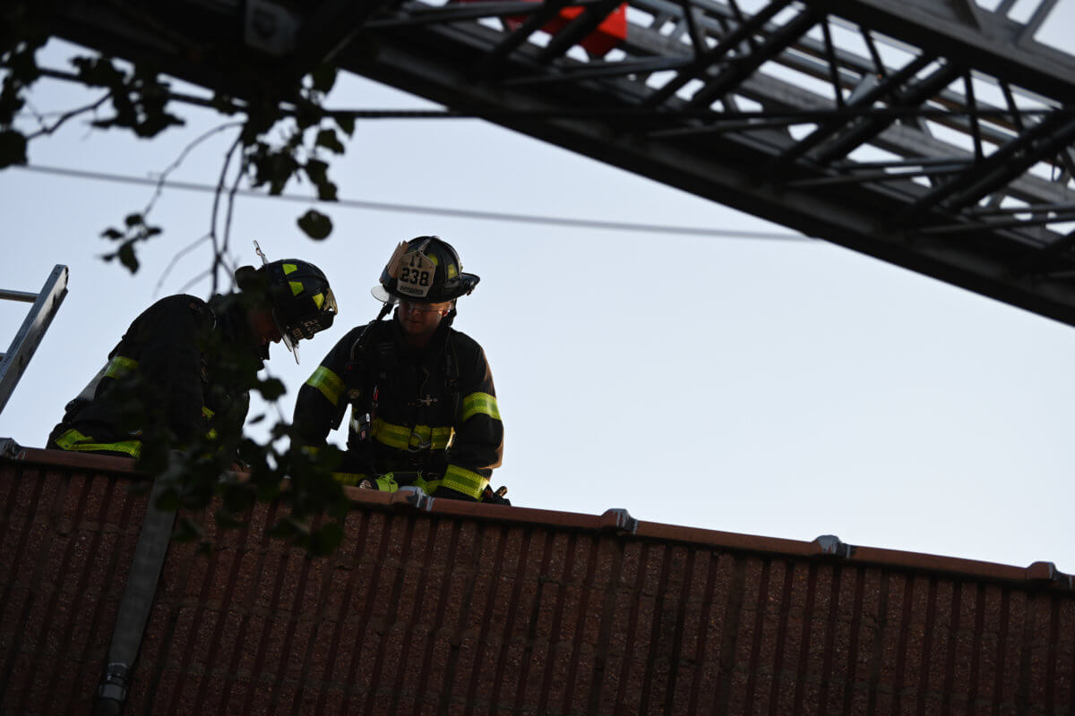 firefighters on the roof of building at two-alarm fire