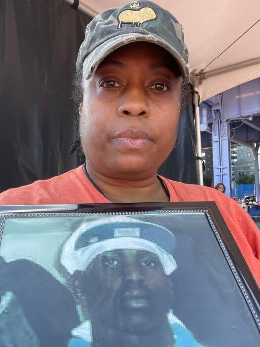 Marie Delus with photo of deceased nephew, who was a victim of gun violence