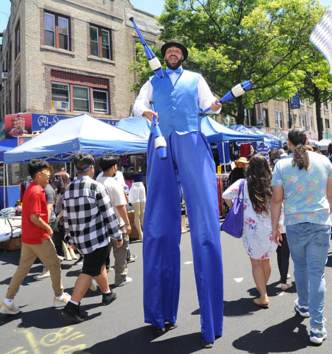 fun on 5th avenue man on stilts in blue suit