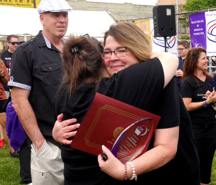 Kathleen Conlon-Nielson being hugged at Relay for Life