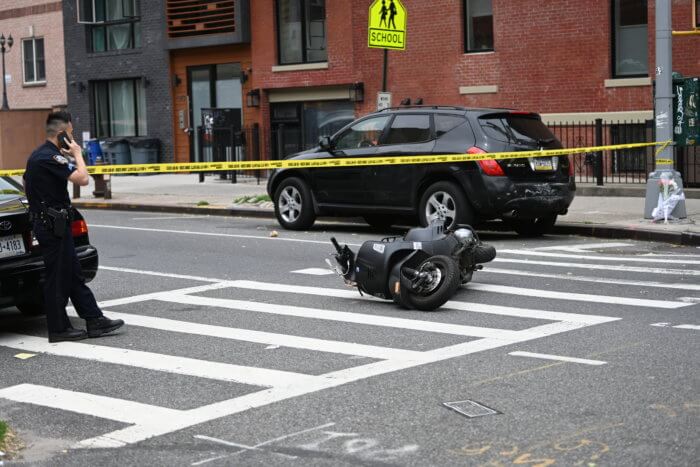 motorcycle in crosswalk with caution tape after a motorcycle rider was hit and killed
