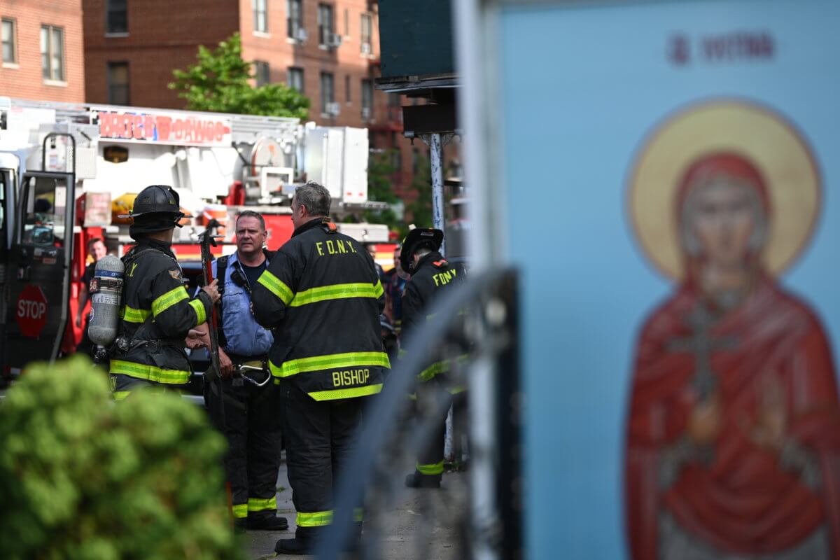 firefighters with religious painting at sheepshead bay united methodist church fire