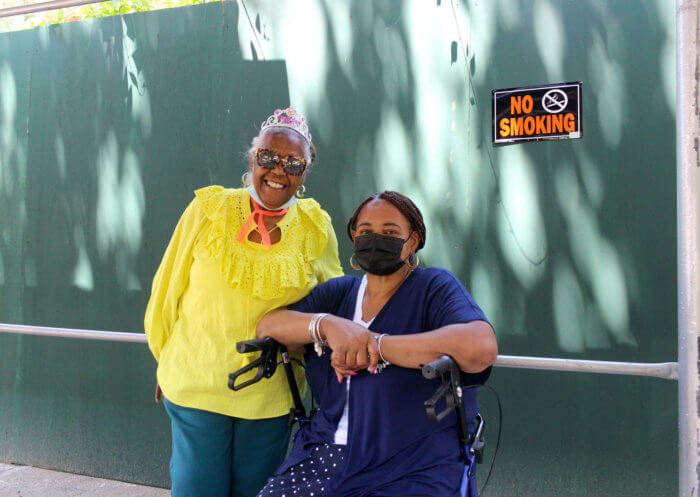 neighbors stand outside 441 willoughby avenue construction fences